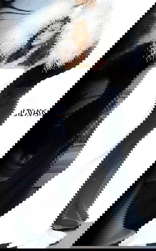 Model wearing Jovani 1226 white gown with feathered sleeves, front view.