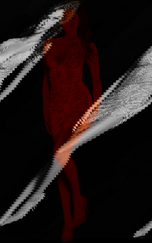 Model wearing Jovani 14338 in neon orange, showcasing the elegant front of the sequined dress.