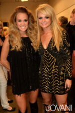 Two models in Jovani 6528 black mini dress with gold details