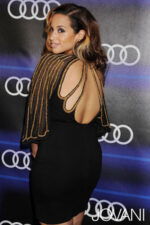 Back view of model wearing Jovani 88586 highlighting open-back design
