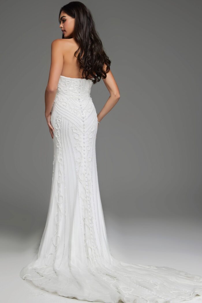 Model wearing JB07050 white gown with embroidery, back view showing subtle train.