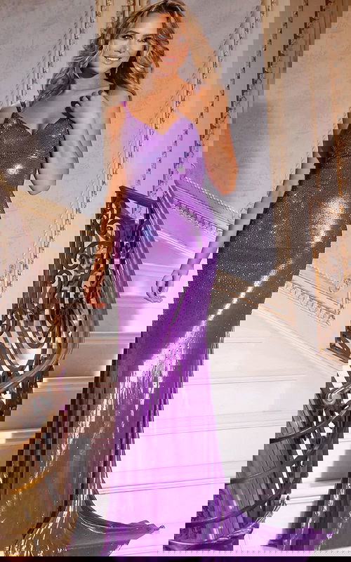 Model wearing Jovani 220110 purple gown with V-neckline and embellishments.