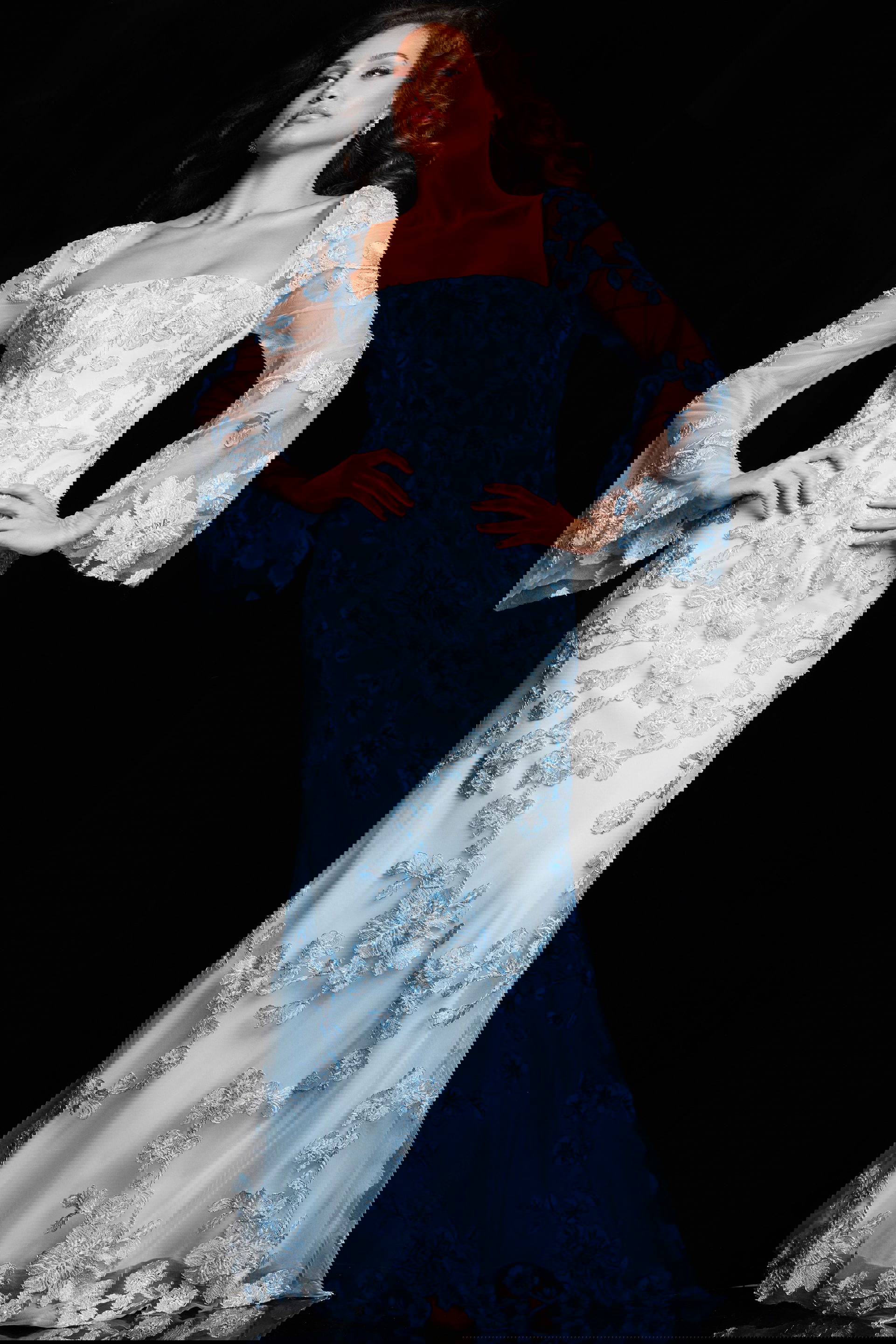 220520_LIGHTBLUE_2018.jpg Model wearing Jovani 220520 light blue gown with floral embroidery and sheer sleeves, front view.