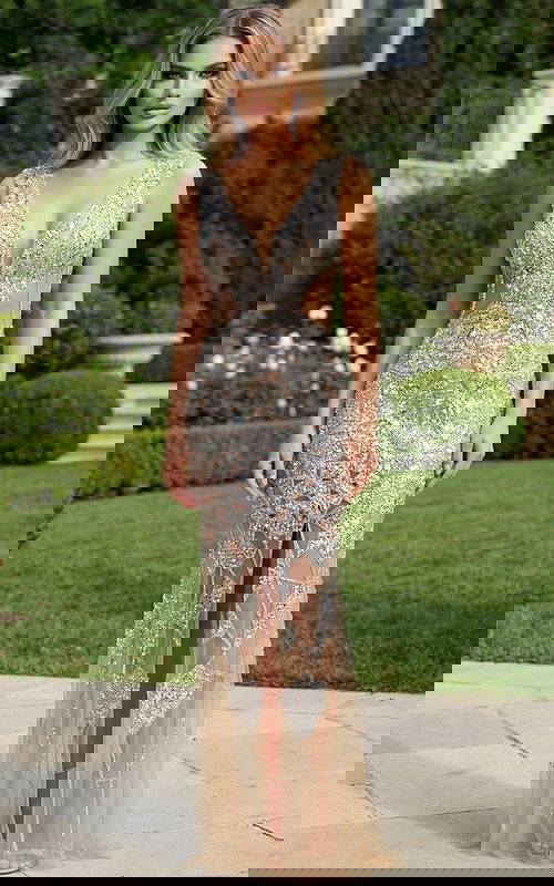 Beaded illusion bridal gown with deep V neckline and fitted silhouette