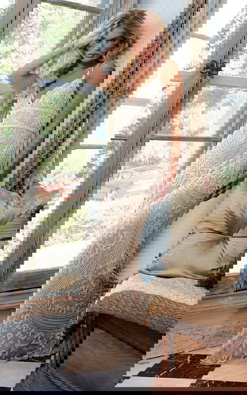 Back view of model wearing Jovani 22286 blue gown with lace-up detail and intricate beadwork.