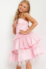 Model in Jovani K22326 pink dress with feather accents, posing elegantly.