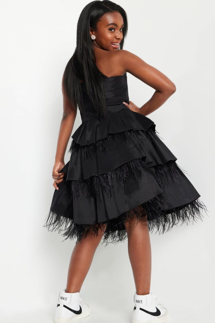 Back view of Jovani K22326 black dress highlighting layered ruffles and feather details.