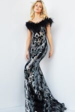 Model wearing Jovani 22346 black gown with metallic embroidery and feathered neckline, front view.