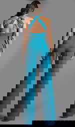 Back view of halter neck jumpsuit with open back, fitted waist, and wide leg silhouette