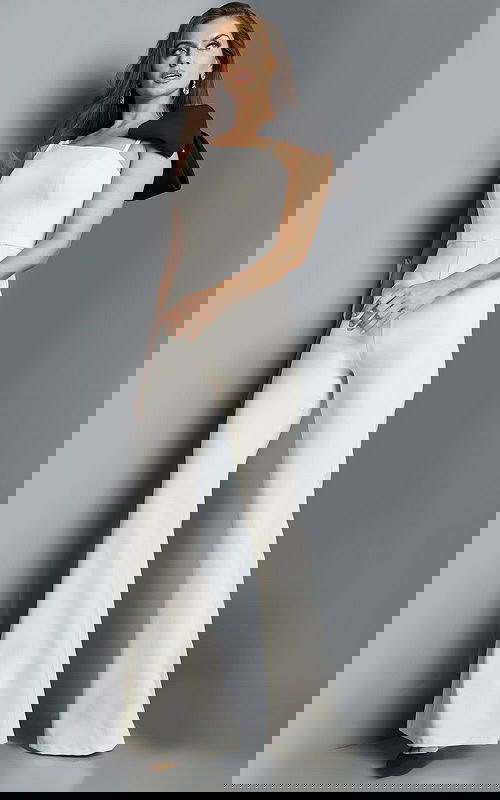 Model wearing Jovani 22589 ivory jumpsuit, front view highlighting the flared legs.