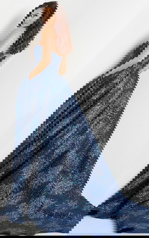 Model wearing Jovani 22792 navy gown showcasing a back view.