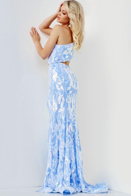 Model posing in Jovani 22853, a blue dress with a high slit and detailed lace.