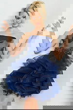 Model wearing Jovani 22901 navy strapless dress with embellished waistband and layered tulle skirt from the front.