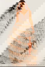 Model in JVN22904 nude gown with sequined ruffles and deep V-neckline