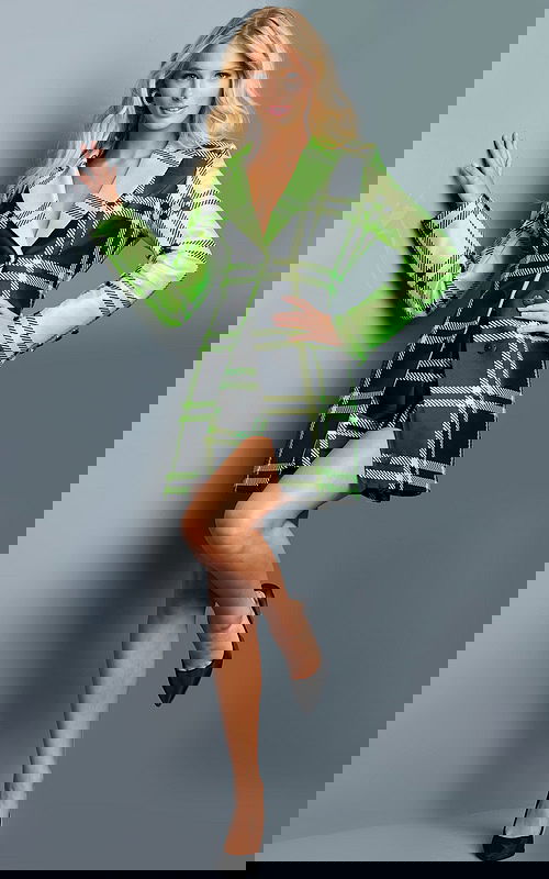 Model wearing 23001 green plaid dress with structured long sleeves and V-neckline, front view.