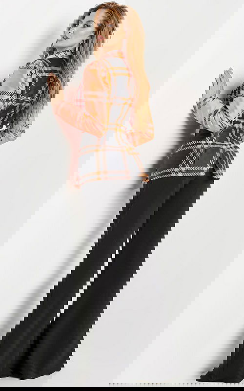 Model wearing Jovani 23002 neon orange plaid blazer dress with black trousers, back view.