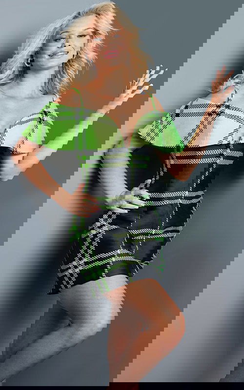 model wearing Jovani 23003 green plaid mini dress with fitted silhouette, front view