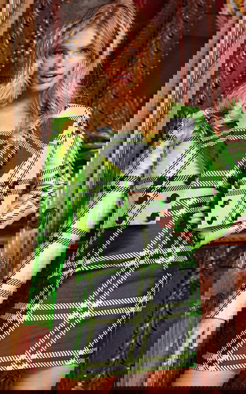 Model wearing Jovani 23004 vibrant green plaid mini dress, front view.