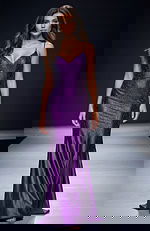 Fitted sequin gown with thin straps, sweetheart neckline, and a smooth floor length silhouette that creates a sleek, modern look