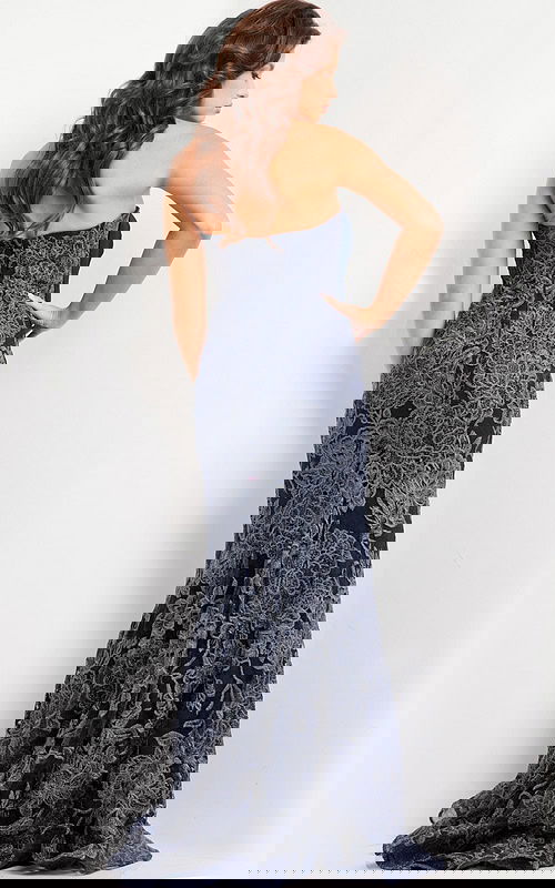 Model wearing Jovani 23031 navy strapless mermaid gown with lace detail, back view.
