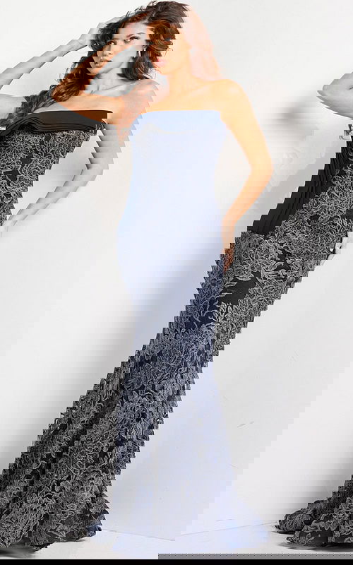 Model wearing Jovani 23031 navy strapless mermaid gown with lace detail, front view.