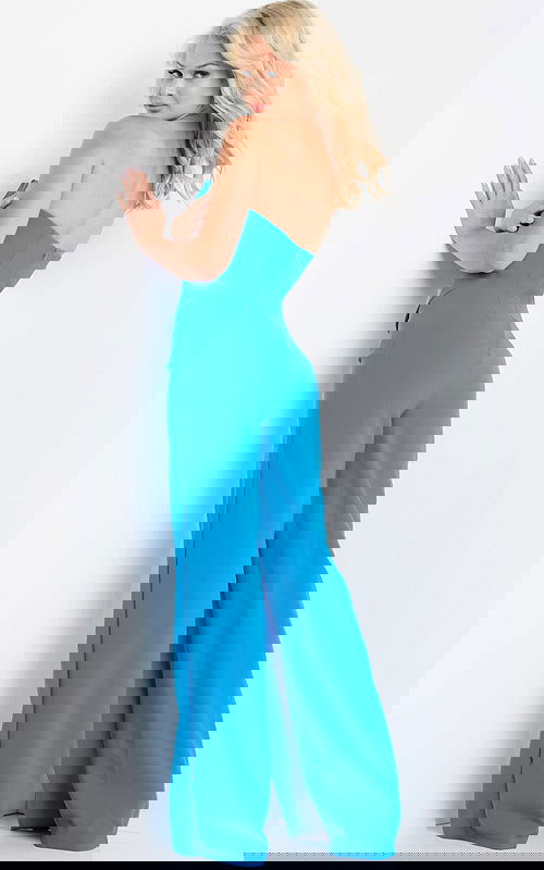 Model showing back view of Jovani 23082 blue strapless jumpsuit.
