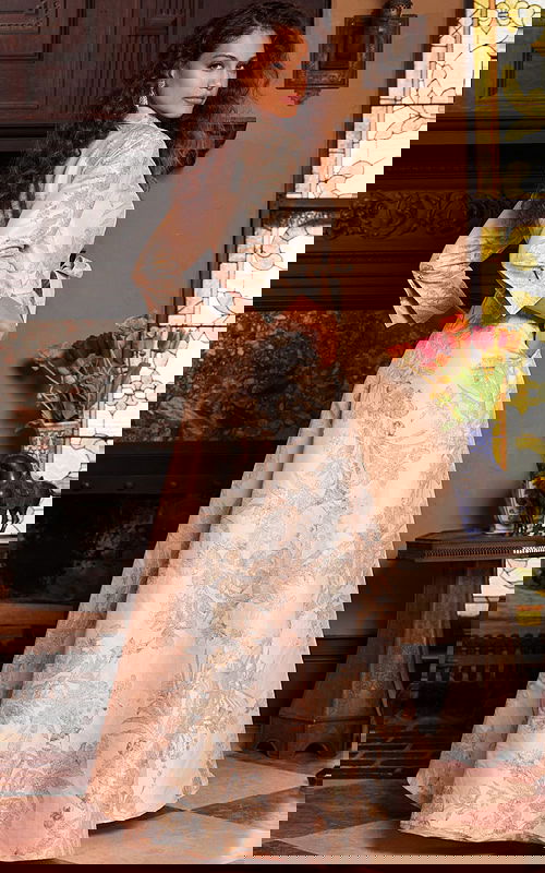 Back view of model wearing Jovani 23178 gold dress with floral pattern