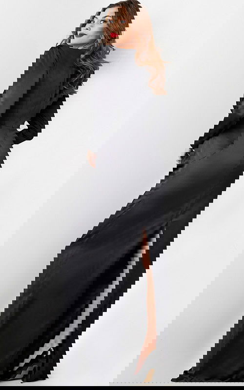 Model wearing Jovani 23180 elegant black gown with subtle back detail, back view.