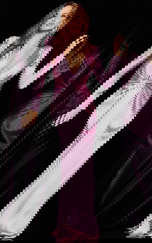 Model wearing Jovani 23180 lilac dress with long sleeves and deep V-neckline.