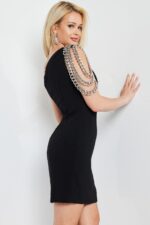 Model showcasing back of Jovani 23239 black mini dress with chain detail.