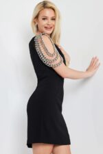 Model wearing Jovani 23239 black dress back view with chain detail visible.