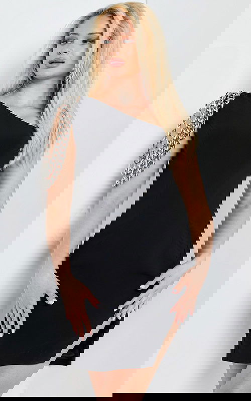 Model wearing Jovani 23239 black dress showing close-up of chain detail and asymmetric neckline.