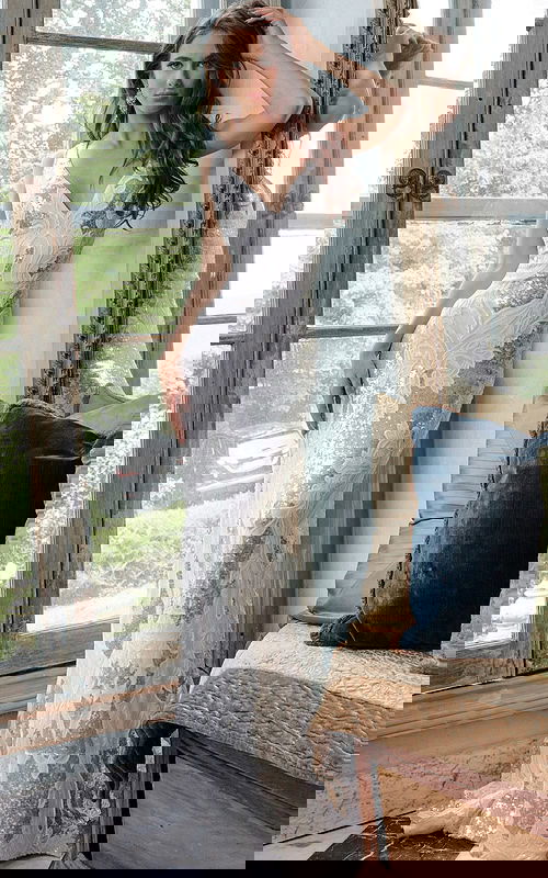 Model wearing Jovani 23319 ivory gown with sequins and intricate details