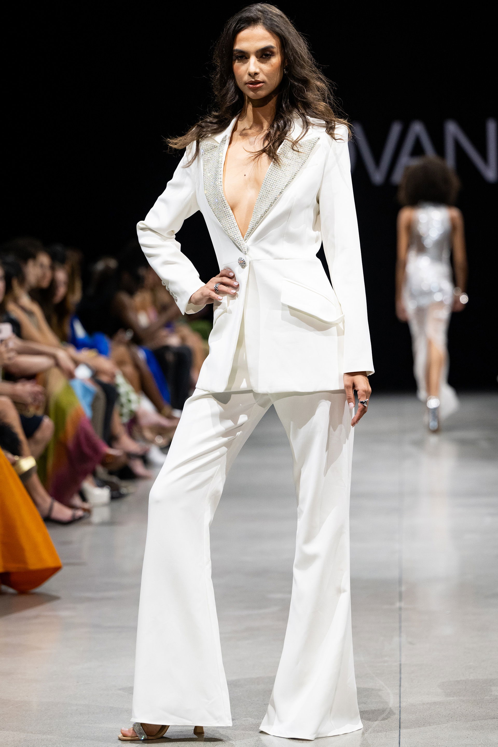 23336.jpg Model wearing Jovani 23336 white suit with embellished lapel and wide-leg pants.