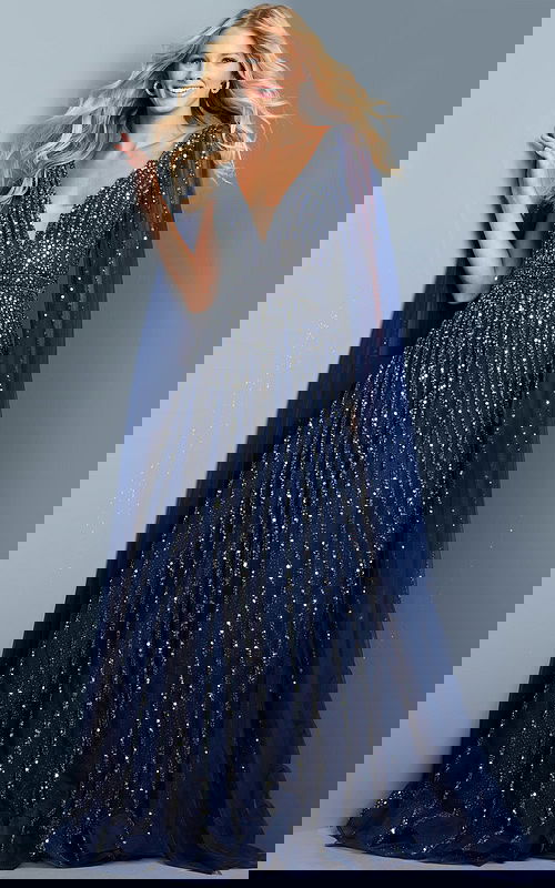 Model wearing Jovani 23362 navy dress with sequins and cape sleeve, front view.