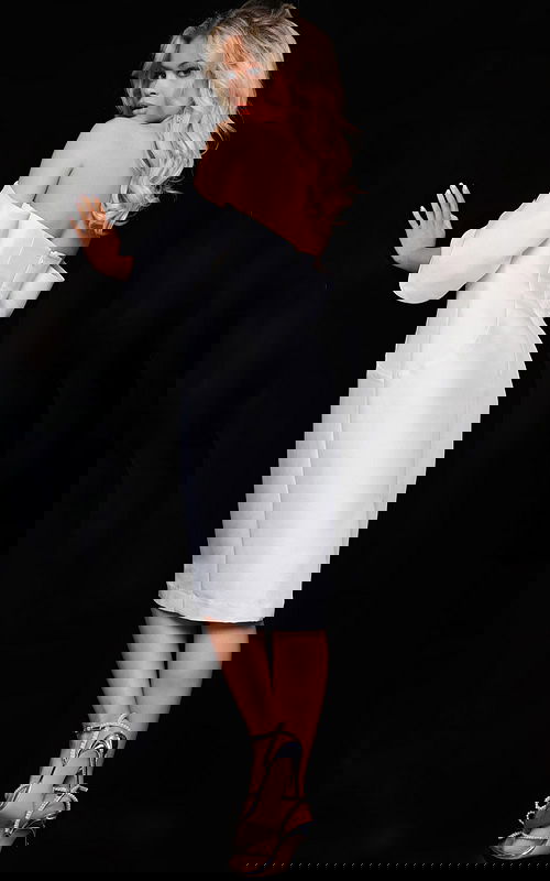 Model wearing Jovani 23397 white dress, back view showing off-the-shoulder design and fitted silhouette