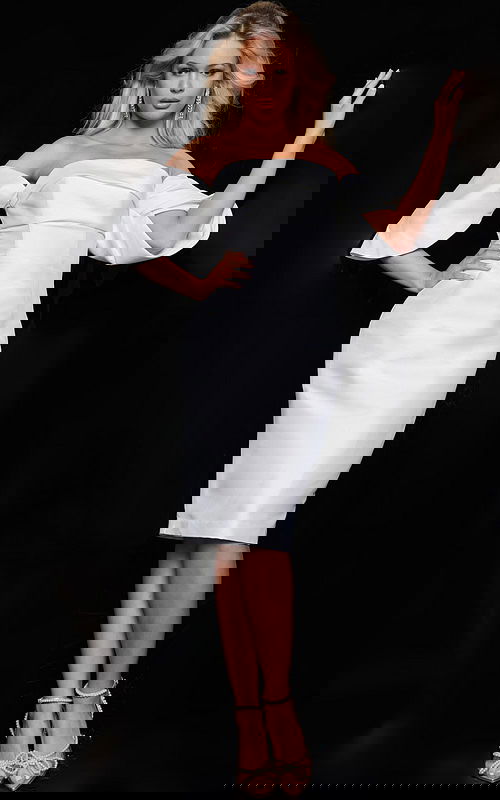 Model wearing Jovani 23397 white dress with off-the-shoulder neckline and puff sleeves, front view