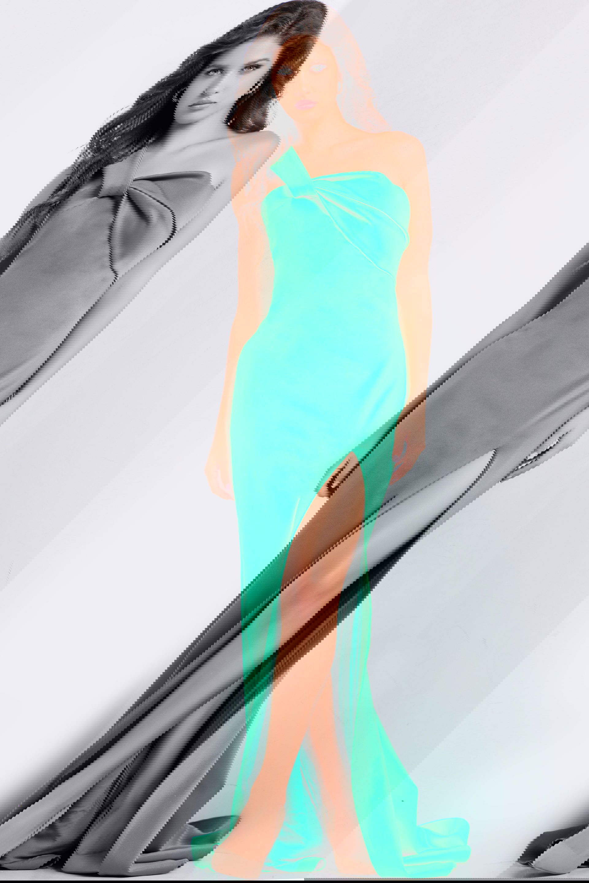 23555_GREEN_3.jpg Model wearing Jovani 23555 green gown with high slit and off-the-shoulder neckline.