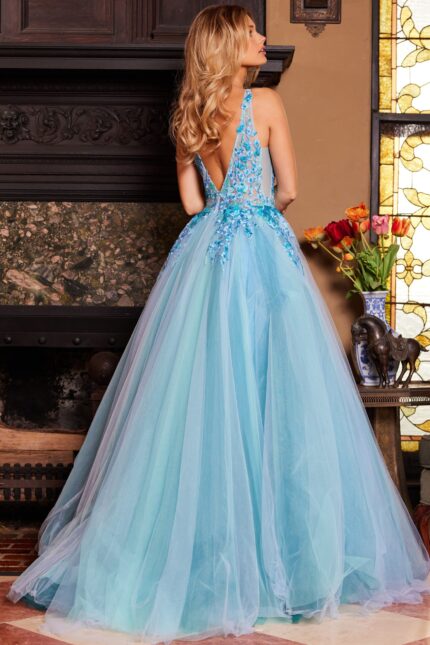 Model wearing Jovani 23577 blue gown with a view of the back and V-shaped backline.