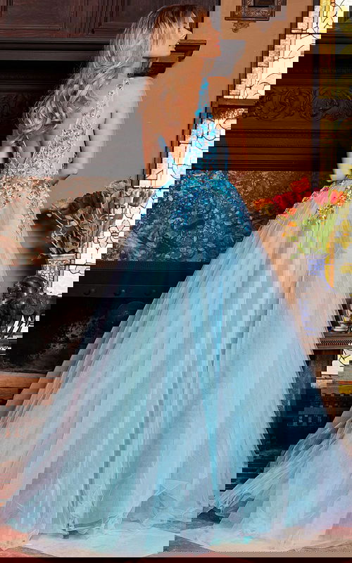 Model wearing Jovani 23577 blue gown with a view of the back and V-shaped backline.