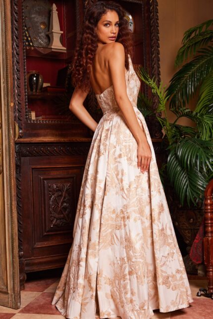 Model wearing Jovani 23625 gold gown, showcasing the back view.