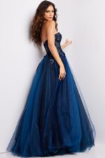 Back view of model wearing Jovani 23641 navy gown with flowing silhouette.