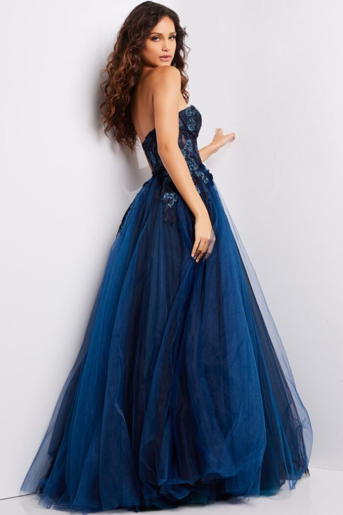 Back view of model wearing Jovani 23641 navy gown with flowing silhouette.