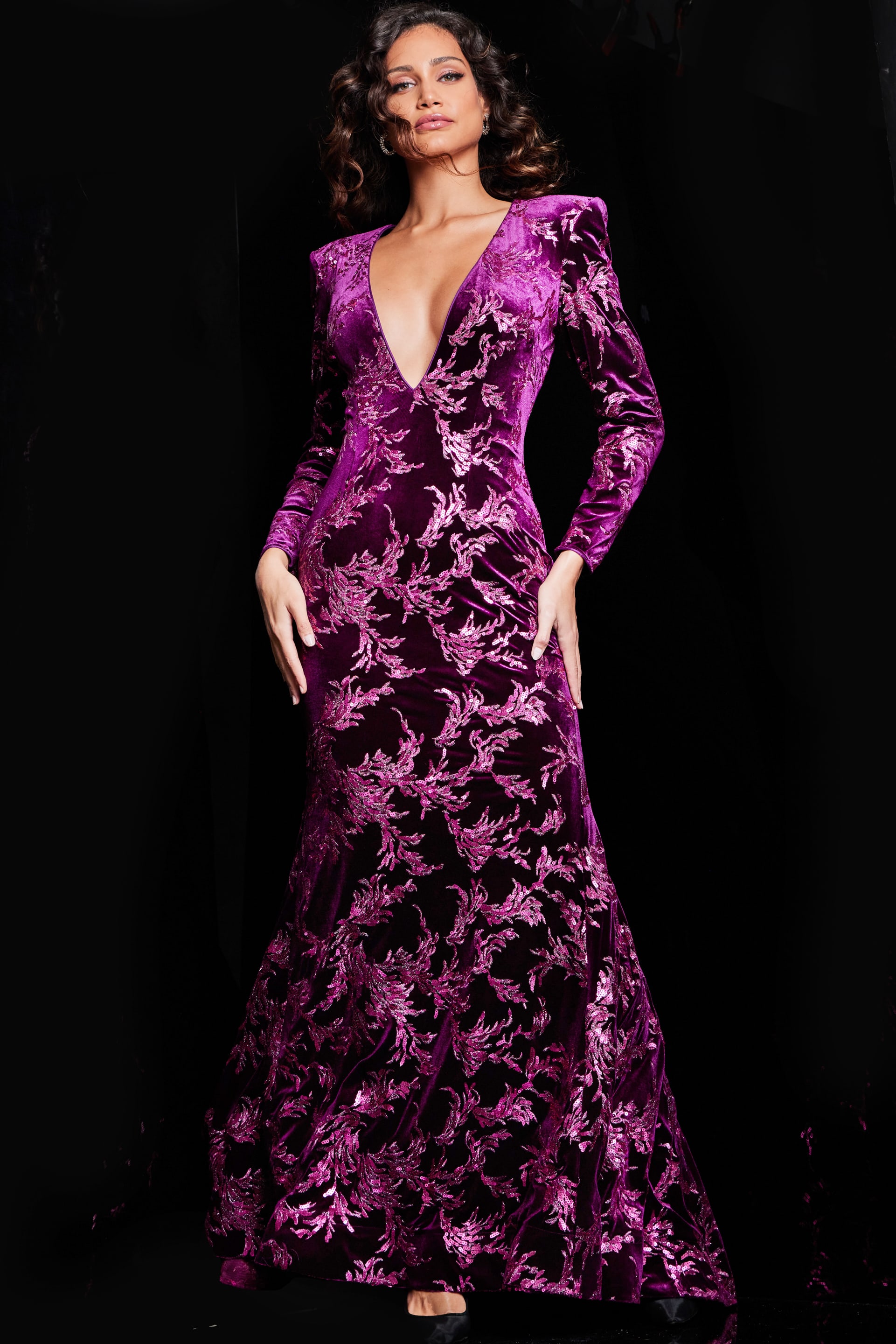 23715_MERLOT_2029-2.jpg Model wearing Jovani 23715 burgundy gown with a plunging V-neckline and long sleeves.
