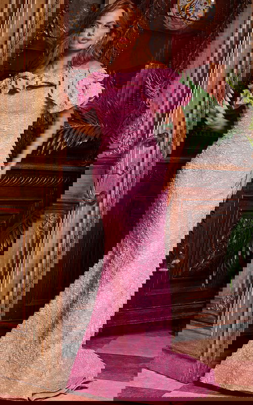 Model wearing Jovani 23847 pink lace dress with ruffled off-the-shoulder neckline