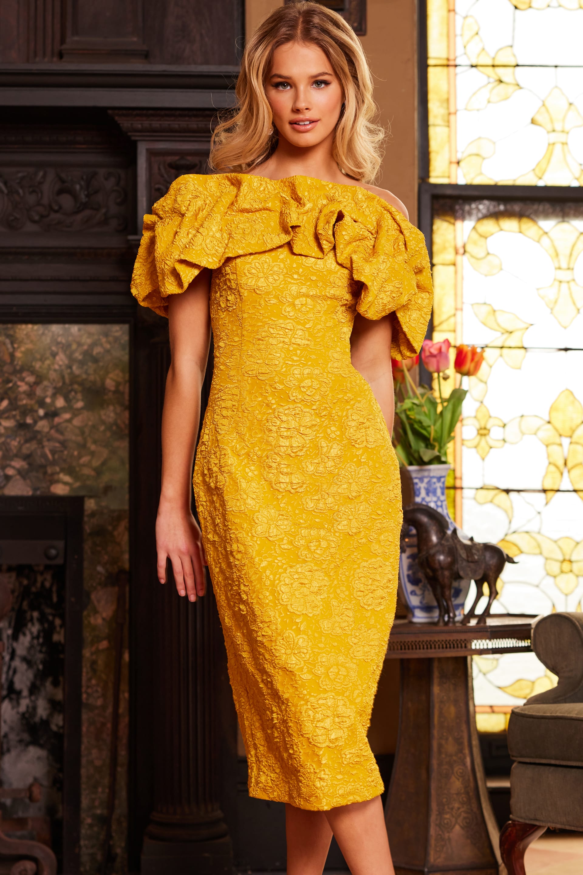 23848-5.jpg Model wearing Jovani 23848 yellow dress with off-the-shoulder neckline and ruffles, front view.