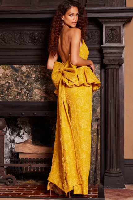 Model wearing Jovani 23849 back view of yellow evening gown featuring an open back design.