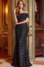 Model in Jovani 23890 black elegant off-the-shoulder dress front view.