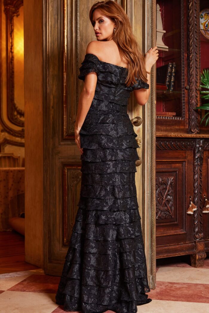 Model in Jovani 23890 black gown showcasing back details.
