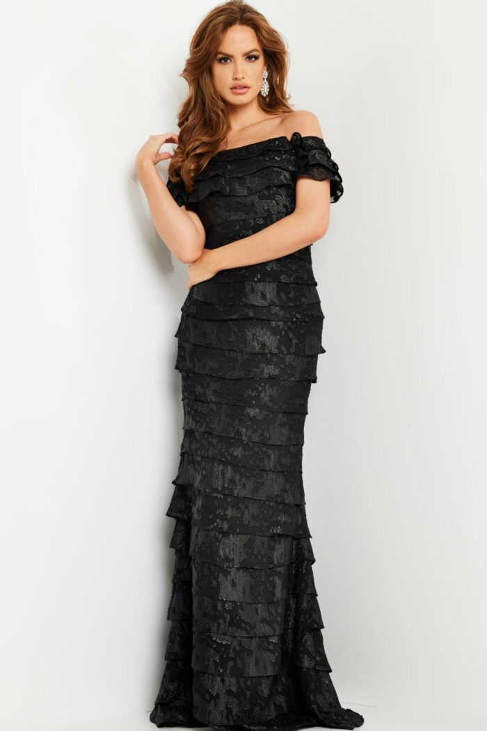 Model in Jovani 23890 black gown, displaying back view and layered texture.
